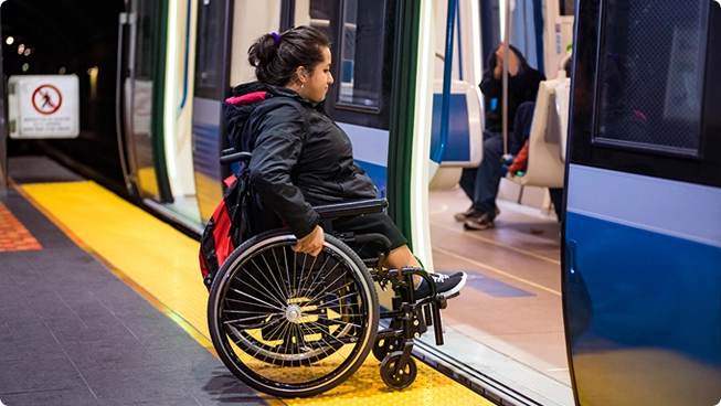 Cliente en fauteuil roulant prenant le métro