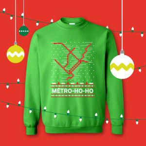 Green holiday sweater featuring métro station puns
